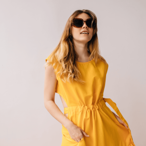 Woman in Yellow Dress and Sunglasses posing